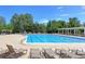 Outdoor community pool with lounge chairs and shade structures at 3230 Boulder Cir # 101, Broomfield, CO 80023