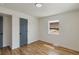 Simple bedroom with hardwood floors and a window offering natural light at 3401 W Virginia Ave, Denver, CO 80219