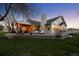 Two story home with large deck and pergola, surrounded by grass at 9362 Tollgate Dr, Longmont, CO 80503