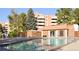 Community pool area with surrounding lounge chairs and building at 2815 S Locust St # F, Denver, CO 80222