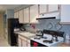 Modern kitchen with black appliances, light cabinets, and a convenient layout at 2815 S Locust St # F, Denver, CO 80222