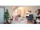 Elegant living room with comfortable seating, a large plant, and a view of a staircase at 2815 S Locust St # F, Denver, CO 80222