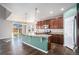 Open concept kitchen with island, granite counters and stainless steel appliances at 328 Beldock St, Brighton, CO 80601