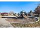 Community playground with play structures and shaded seating at 328 Beldock St, Brighton, CO 80601