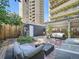 Relaxing backyard patio with seating area, mature trees, and brick pavers at 1163 Vine St, Denver, CO 80206