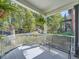 Relaxing front porch with a metal bench and treetop views at 1163 Vine St, Denver, CO 80206