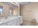 Main bathroom with double vanity and a bathtub at 16 Whitehaven Cir, Highlands Ranch, CO 80129