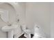 Clean and simple powder room with pedestal sink and toilet at 207 S Irvington St, Aurora, CO 80018