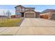 Two-story house with stone and siding exterior, attached garage, and landscaped yard at 207 S Irvington St, Aurora, CO 80018