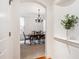 Formal dining room with chandelier and wood table at 8715 E Iliff Dr, Denver, CO 80231