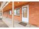 Brick building entry with white door and windows at 1143 Lamar St # 3, Lakewood, CO 80214