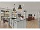 Open concept kitchen with island, living area view, and hardwood floors at 2614 Hillcroft Ln, Castle Rock, CO 80104