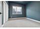 Spacious bedroom with carpeting, a large window, and teal walls at 3830 Jason St # 4, Denver, CO 80211