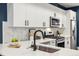 Modern kitchen sink and faucet with white quartz countertops at 3830 Jason St # 4, Denver, CO 80211