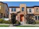 Two-story townhome with orange door and landscaping at 8459 Sheps Way, Broomfield, CO 80021