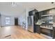 Open concept living room with wood floors and view of kitchen at 802 Centennial Way, Bennett, CO 80102