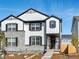 Two-story home with stone and white siding, a front porch, and a landscaped yard at 774 N Shawnee St, Aurora, CO 80018