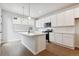 Modern kitchen with white cabinets, island, and stainless steel appliances at 455 Interlocken Blvd # 105, Broomfield, CO 80021