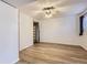 Well-lit bedroom with wood-look floors and closet at 7665 E Eastman Ave # 106A, Denver, CO 80231