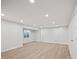 Large finished basement with laminate flooring and recessed lighting at 6690 S Sheridan Blvd, Littleton, CO 80123