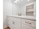 Basement bathroom with white vanity, quartz countertop, and walk-in shower at 6690 S Sheridan Blvd, Littleton, CO 80123