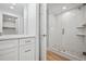 Basement bathroom features a walk-in shower with pebble flooring at 6690 S Sheridan Blvd, Littleton, CO 80123