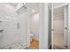 Clean basement bathroom with a glass shower, marble tile, and a toilet at 6690 S Sheridan Blvd, Littleton, CO 80123
