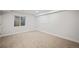 Finished basement with neutral walls and carpeted floors at 6690 S Sheridan Blvd, Littleton, CO 80123