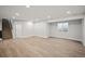Finished basement with laminate flooring and ample space at 6690 S Sheridan Blvd, Littleton, CO 80123
