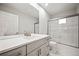 Clean bathroom with a bathtub, shower, and a double vanity at 6690 S Sheridan Blvd, Littleton, CO 80123