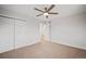 Spacious bedroom with double doors and neutral carpeting and walls at 6690 S Sheridan Blvd, Littleton, CO 80123