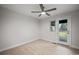 Comfortable bedroom with ceiling fan and backyard access at 6690 S Sheridan Blvd, Littleton, CO 80123