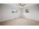 Bright bedroom with neutral walls and carpeting, featuring two windows at 6690 S Sheridan Blvd, Littleton, CO 80123