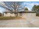 Brick ranch house with a three-car garage and well-maintained landscaping at 6690 S Sheridan Blvd, Littleton, CO 80123