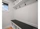 Functional laundry area with built-in bench and storage at 6690 S Sheridan Blvd, Littleton, CO 80123