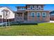 Two-story home with brick and siding exterior, a welcoming porch and landscaped lawn at 3179 Boral Owl Dr, Brighton, CO 80601