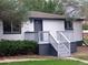 Newly renovated ranch home with gray deck and walkway at 2635 S Josephine St, Denver, CO 80210