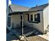 House exterior featuring a covered porch and landscaping at 1348 Tamarac St, Denver, CO 80220