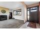 Living room with fireplace, built in shelves, and carpet at 11505 Roxburg St, Strasburg, CO 80136