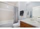 Bathroom features a bathtub, toilet and vanity with a large mirror at 8547 Gold Peak Dr # G, Highlands Ranch, CO 80130