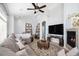 Bright living room features a fireplace, large sectional sofa, and a mounted TV at 8547 Gold Peak Dr # G, Highlands Ranch, CO 80130