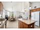 Eat-in kitchen with island, granite countertops, and view into dining area at 8547 Gold Peak Dr # G, Highlands Ranch, CO 80130