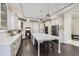 Modern kitchen features white cabinets, expansive island, and stainless steel appliances at 7587 Wright Ct, Arvada, CO 80005