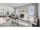 Open living room with stone fireplace and hardwood floors at 7587 Wright Ct, Arvada, CO 80005