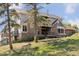 Two-story home with stone accents and a large deck at 12421 High Country Trl, Littleton, CO 80127