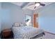 Cozy basement bedroom with a queen-size bed and wood door at 12421 High Country Trl, Littleton, CO 80127