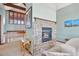 Stone fireplace creates a cozy ambiance in this sitting area at 12421 High Country Trl, Littleton, CO 80127