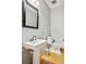 Clean and modern half bathroom with pedestal sink and classic toilet at 12421 High Country Trl, Littleton, CO 80127