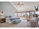 Primary bedroom with king-size bed, large windows, and access to deck with mountain views at 12421 High Country Trl, Littleton, CO 80127