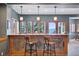 Basement bar with seating, stone accents, and mountain views at 12421 High Country Trl, Littleton, CO 80127